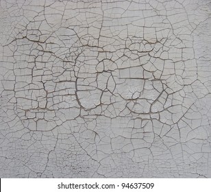 subtle cracked paint pattern on white wall with hidden number