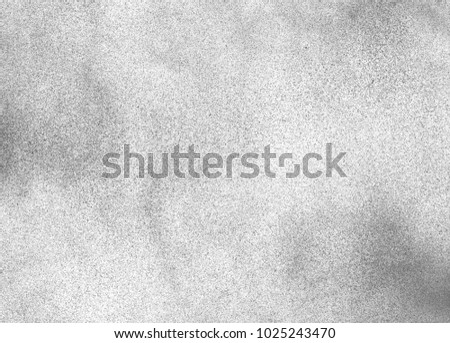 Subtle grain texture. Abstract black and white gritty grunge background. Dark paint spray particles on paper