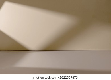 Subtle lines of light and shadow from the window fall across the floor and wall of a clean, unoccupied room.