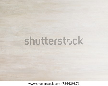 Subtle near white pickled cool tan wood board surface shows subtle grain fade to white