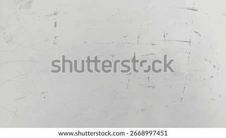 Subtle textured white surface with fine scratches and speckled dust particles. Grunge dust and scratch texture on clean white background. Vintage grunge effect with dust and lines.