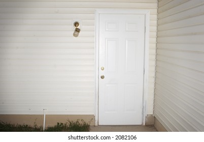 Suburb Door With Siding On The House And A Broken Light Fixture