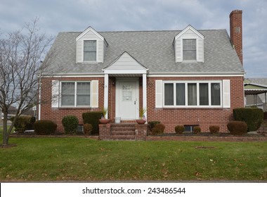 Suburban Brick Cape Cod Style Home Overcast Sky Residential Neighborhood USA