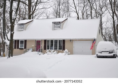 Suburban Cape Cod Style Home After Winter Snow Storm In USA