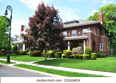 Suburban Gable Front Style Home Residential Neighborhood Sunny Blue Sky Clouds Street