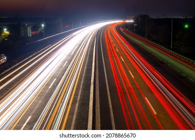 Suburban highway at night. Traces from headlights and taillights of heavy traffic