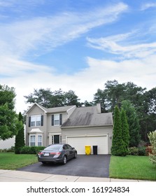 Suburban Home Residential Neighborhood USA Blue Sky Clouds Parked Car Trash Cans