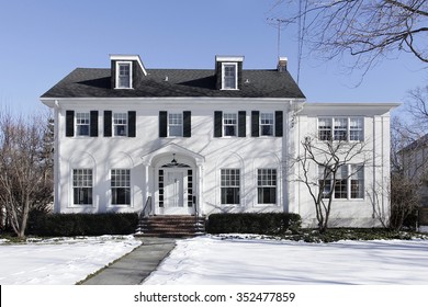 Suburban Home In Winter With Black Shutters
