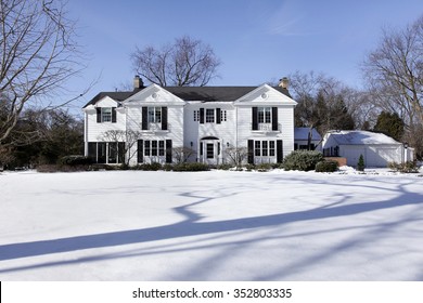 Suburban Home In Winter With Detached Garage