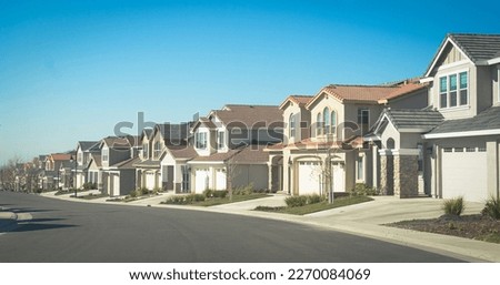 Suburban homes in a row with empty driveways