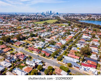 Suburban homes/rooftops in Perth, Western Australia, photographed from a drone including the Perth City skyline. Perth, Australia.
