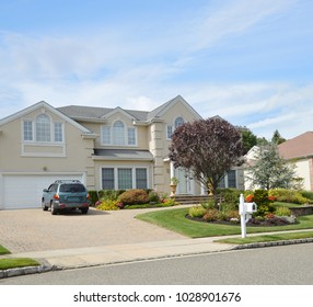 Suburban McMansion Home Parked Car In Driveway Blue Sky USA