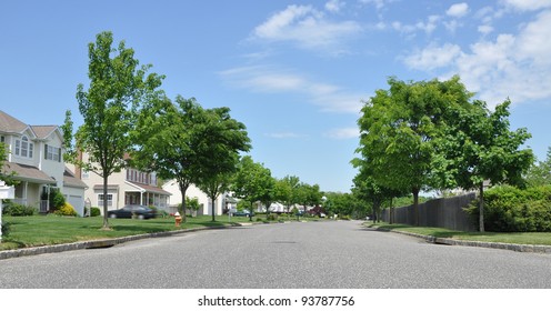 Suburban Neighborhood Street On Sunny Blue Sky Day
