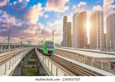 Suburban passenger rail transport, overground metro among skyscrapers in a modern city