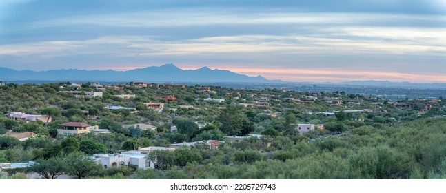 Suburban Residential Area With Trees Against The Silhoutte Of A Mountain Range In Tucson, Arizona. Panorama Of A Neighborhood And A Pink Sky Horizon At The Background.