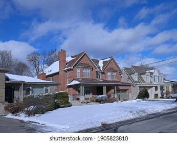 Suburban Residential Neighborhood With Single Family Houses With Large Front Yards On A Sunny Day In Winter