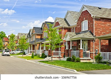 Suburban residential street with red brick houses