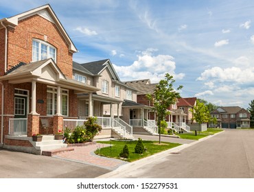 Suburban Residential Street With Red Brick Houses