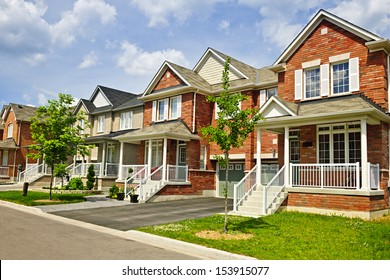 Suburban residential street with row of red brick houses
