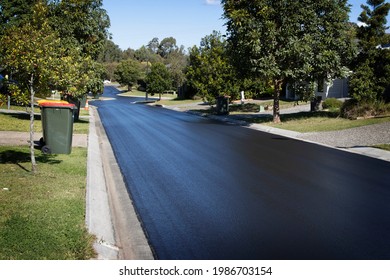 Suburban Road Resurfaced with Fresh Asphalt. Construction of new tar bitumen in a residential housing area.