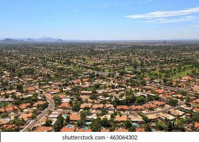 Suburban Scottsdale, Arizona Skyline Above Rooftops, Swimming Pools And Golf Course