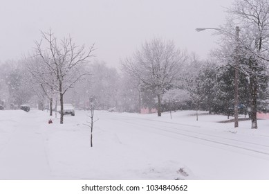 Suburban Street Covered In Heavy Winter Snow