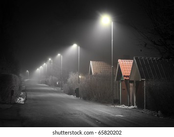 Suburban Street On A Foggy Evening