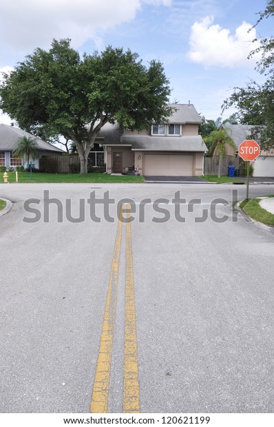 Suburban Street Stop Sign\
Home Snout Back Split Architecture Residential Neighborhood Blue\
Sky Clouds