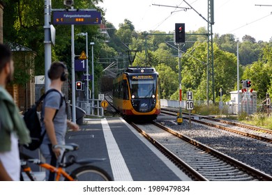 A suburban train or AVG tram (Albtal-Verkehrs-Gesellschaft) arrives at the railway station. The concept of modern transport, movement, tourism. Bad Wimpfen, Germany - August 8, 2019