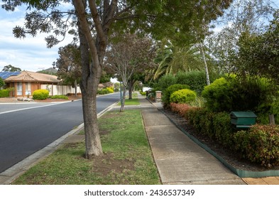 A suburban tree-lined Street with beautiful front yard Gardens in a Quiet Residential Area. Tranquil Australian Neighbourhood. Concept of real estate, housing market in Melbourne VIC Australia. - Powered by Shutterstock