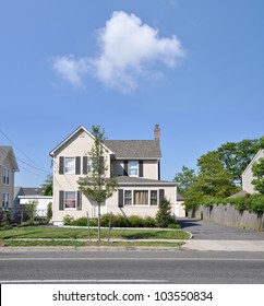 Suburban Two Story Home On Residential Neighborhood Street Sunny Blue Sky Day Cloud