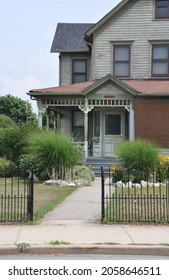 Suburban Victorian Home With Rod Iron Fence 