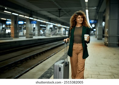 In the subway, a businesswoman with takeaway coffee in hand pulls a suitcase. - Powered by Shutterstock