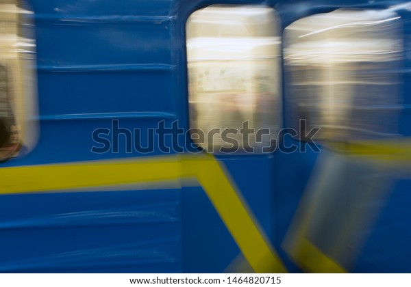 subway passengers in the window of a moving\
car on a deliberately blurred\
background