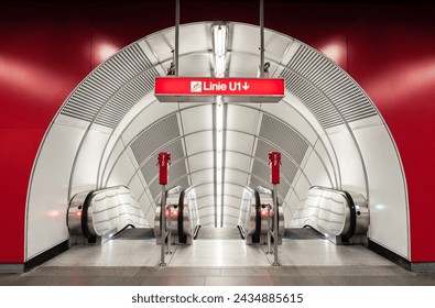 Subway station escalators. Entrance from hall with red walls into empty white tunnel with three moving staircases. Symmetric view of arch-shaped underground station escalator tunnel. - Powered by Shutterstock