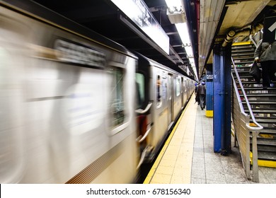 A subway is swifting by the platform of a subway station.