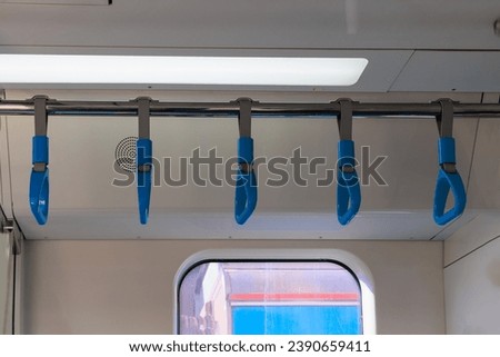 Subway train carriage, interior with blue seats and handrails