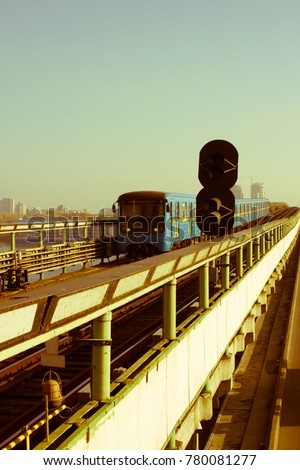 subway train on metro-bridge, approaching Dnipro station, Kiev, Ukraine. Retro style