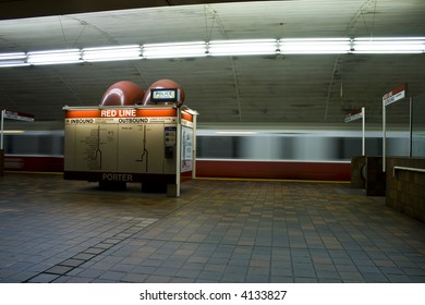 Subway train passing behind an information booth at the station stop