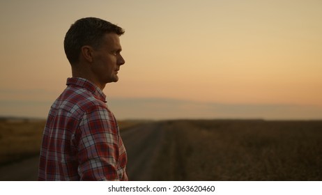 Succesful Agronomist Man Inspect Harvest In Sunrise Morning Farmland. Inspiring Manager Face At Gold Panoramic Field. Business Owner At Agrrian Wheat Land. Organic Agricultural Environment Concept. 