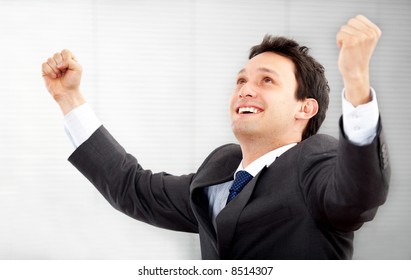 Succesful Business Man In An Office With His Arms Up