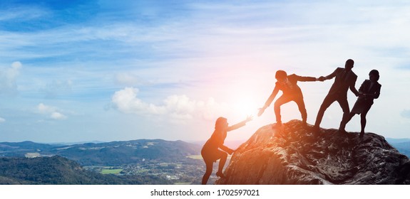 Success of business concept. Partnership of business. Group of businessperson on the mountaintop. - Shutterstock ID 1702597021
