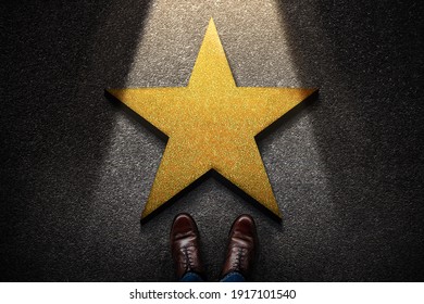 Success in Business or Personal Talent Concept. Top View of Business Person in Working Shoes Standing in front of a Golden Star. Light Shining on the Dark Cement Floor - Shutterstock ID 1917101540