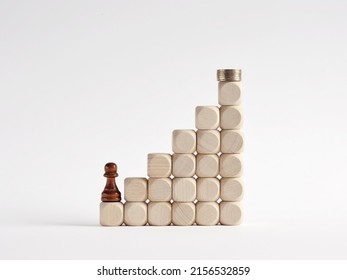 Success In Business And Reaching Financial Goals Concept. Chess Pawn Climbing The Ladder Leading Towards The Stacked Coins.