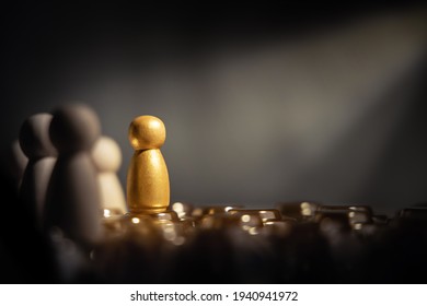 Success in Business or Talent Concept. Stand Out from the Crowd. Different and Individual Unique Person. Spotlight Shining to the Golden. presenting by wooden peg dolls - Shutterstock ID 1940941972
