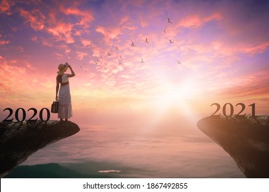 Success Businesswoman Of New Year 2021 Concept: Silhouette Businesswoman Looking Forward To 2021 On Mountain Sunrise Background