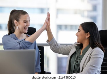 Success Can Be A Team Effort Too. Shot Of Two Young Businesswoman Giving Each Other A High Five In An Office At Work.