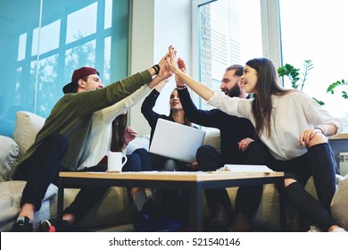 Success concept, Young talented crew of graphic designers made good job feeling proud and exciting when finishing project in friendly atmosphere while high-fiving with colleagues in coworking space - Powered by Shutterstock