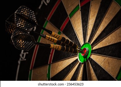 Success hitting target aim goal achievement concept background - three darts in bull's eye close up - Shutterstock ID 236453623