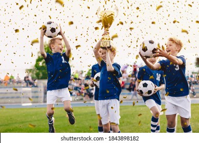 Success of kids football team in tournament final game. Happy boys in school sports team winning soccer championship. Children smiling and rising up golden cup on trophy ceremony - Powered by Shutterstock